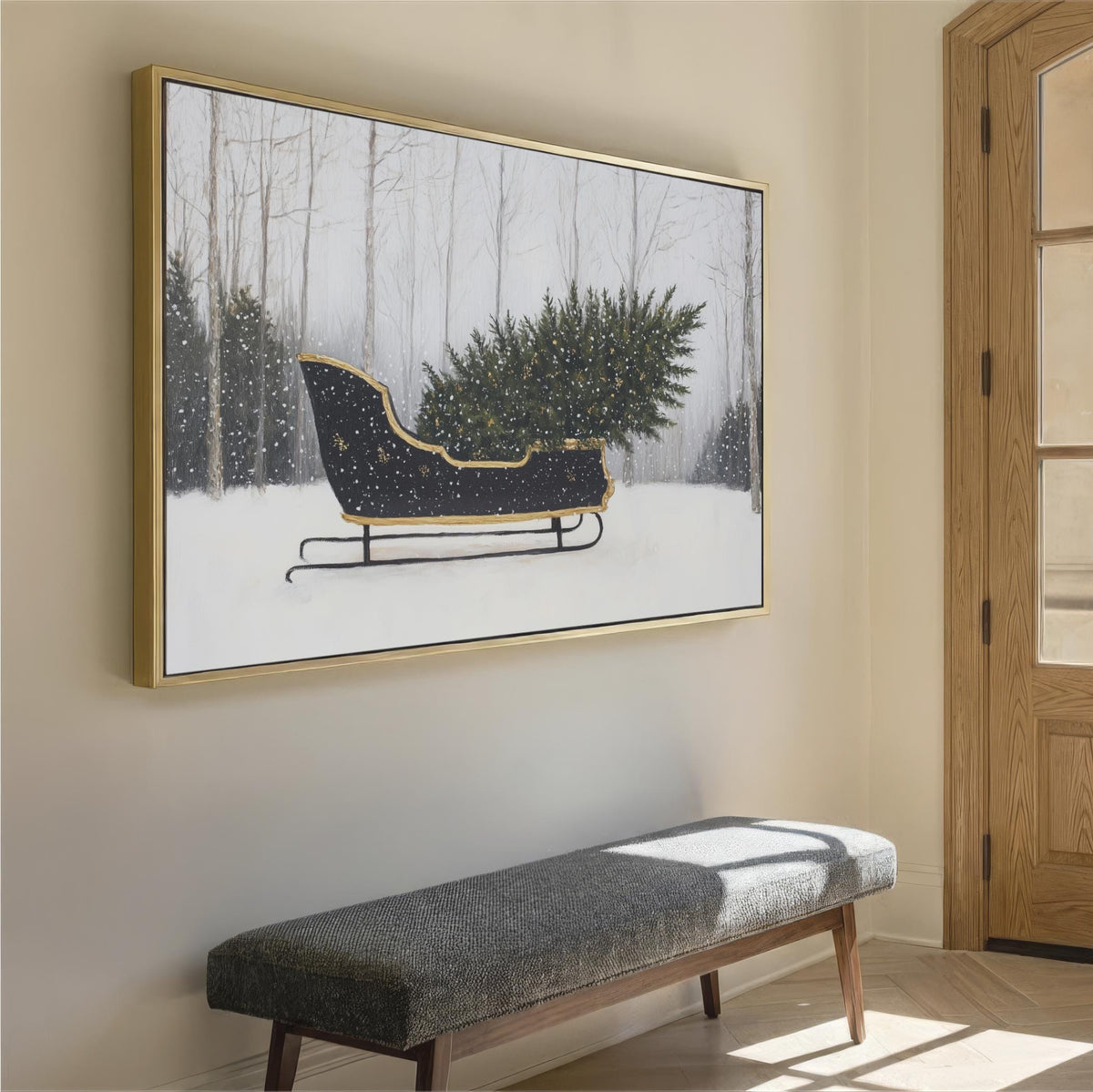 a large framed painting of a black sled carrying a Christmas tree, hanging on a wall in a room with a wooden door and a bench.