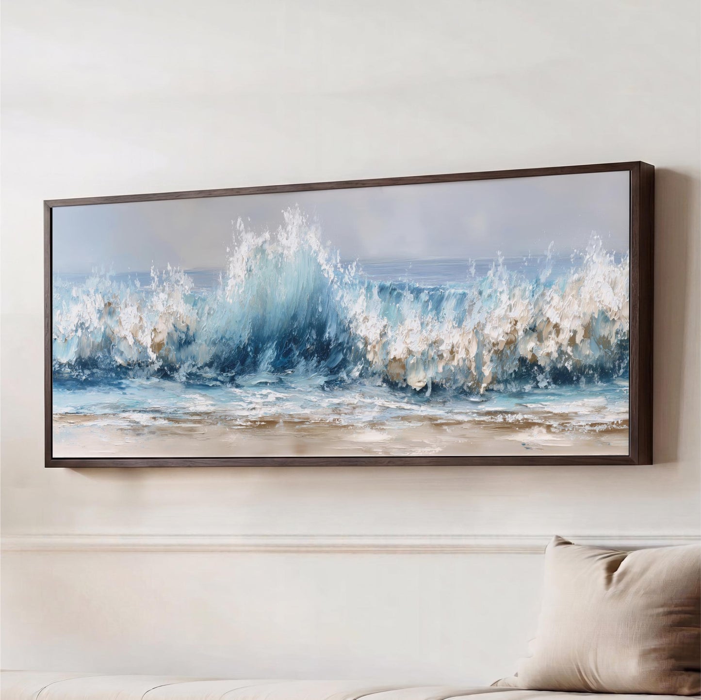 a large framed painting of a crashing wave, hanging on a wall above a couch.