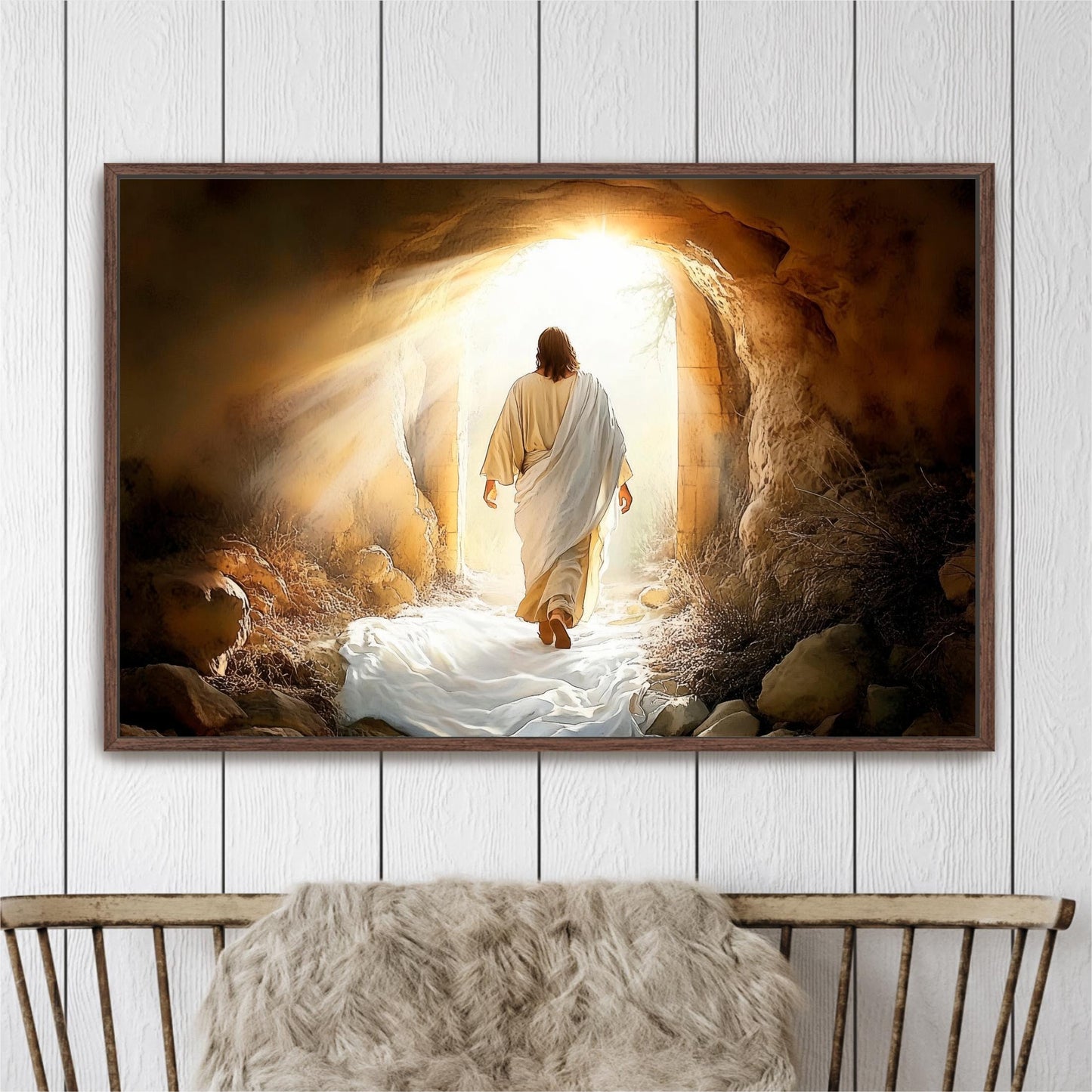 A framed painting depicting a figure in a robe walking through a tunnel with a bright light at the end, surrounded by rocks and vegetation.