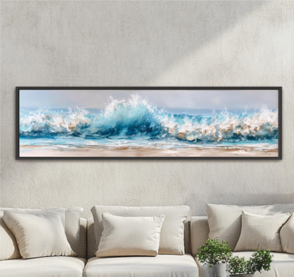 A large framed painting depicting a serene ocean scene with crashing waves is hanging on a wall above a beige sofa.