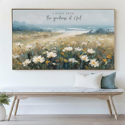 a large painting of a field of white flowers hanging on a wall above a wooden bench.