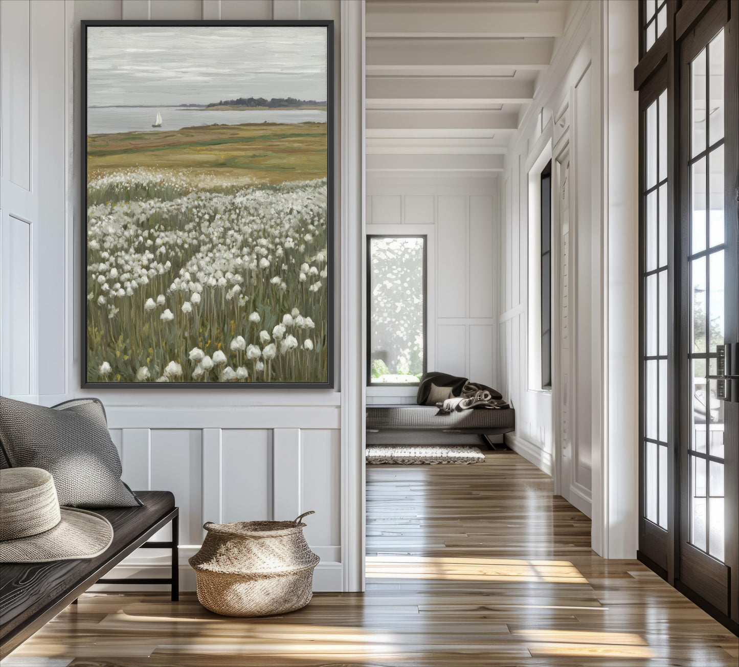 a serene and well-lit living room with a large painting of a field of white flowers hanging on the wall. The room has a wooden floor and white walls, creating a warm and inviting atmosphere.