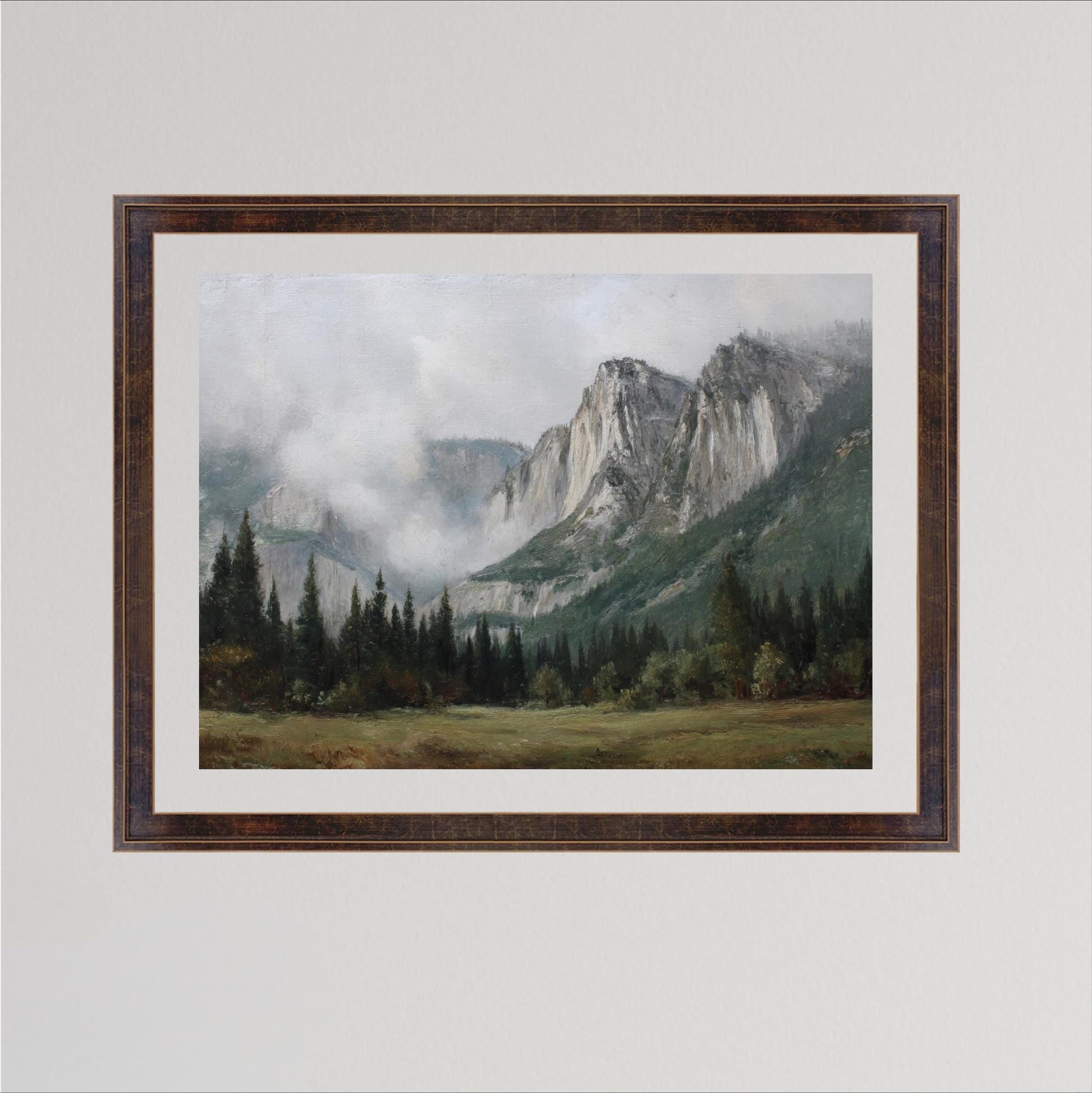 The image is a framed painting depicting a mountainous landscape with a forested area in the foreground and a misty, hazy mountain range in the background.