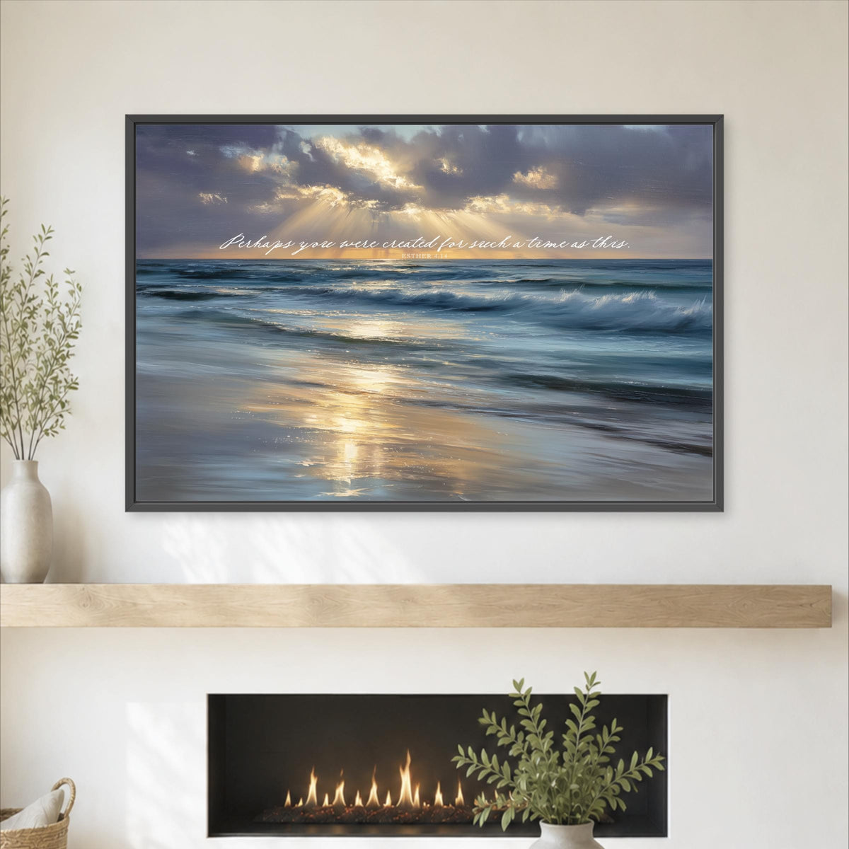 a framed photograph of a serene beach scene with a sunset over the ocean, hanging on a wall above a fireplace.