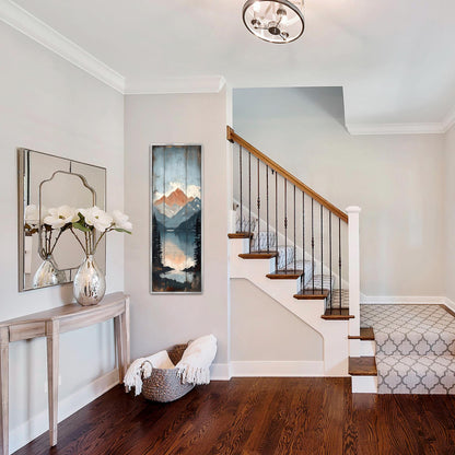 a well-lit and organized entryway with a wooden staircase, a mirror, a console table with a vase of flowers, and a painting on the wall.
