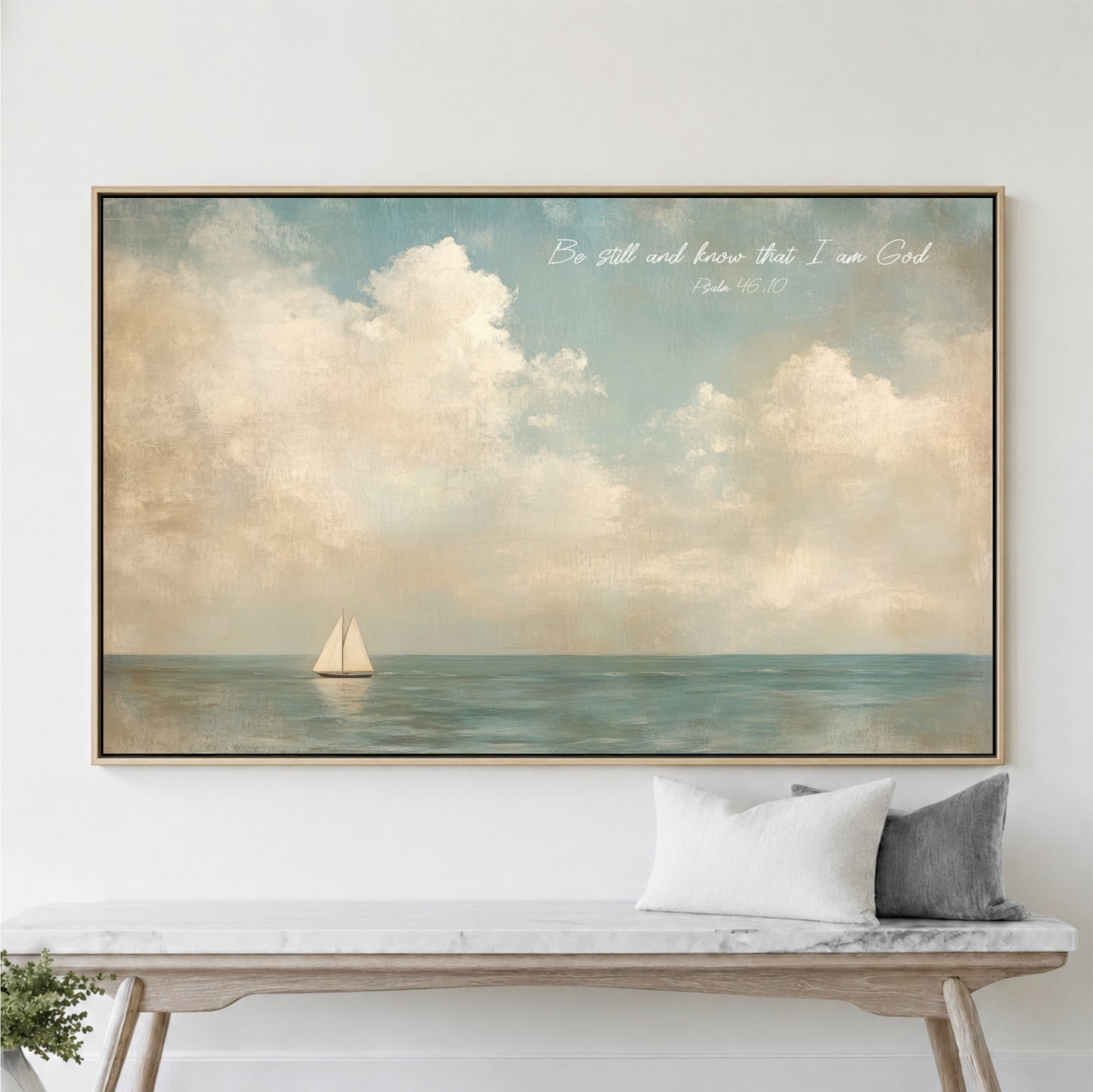 a large framed painting of a sailboat on the ocean, with a cloudy sky in the background.