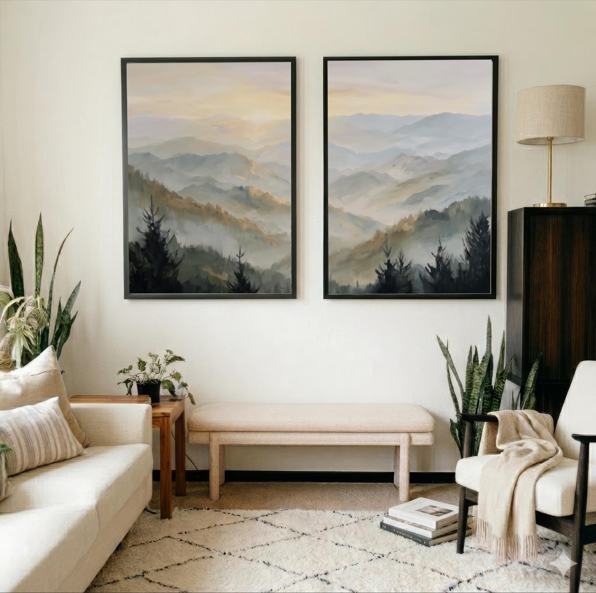 a cozy living room with two large framed landscape paintings hanging on the wall, depicting a serene mountain scene. The room is furnished with a white sofa, a wooden side table, and a beige armchair, creating a warm and inviting atmosphere. The room is also adorned with several potted plants, adding a touch of greenery and natural beauty to the space.