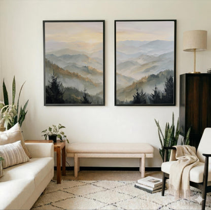 a cozy living room with two large framed landscape paintings hanging on the wall, depicting a serene mountain scene. The room is furnished with a white sofa, a wooden side table, and a beige armchair, creating a warm and inviting atmosphere. The room is also adorned with several potted plants, adding a touch of greenery and natural beauty to the space.