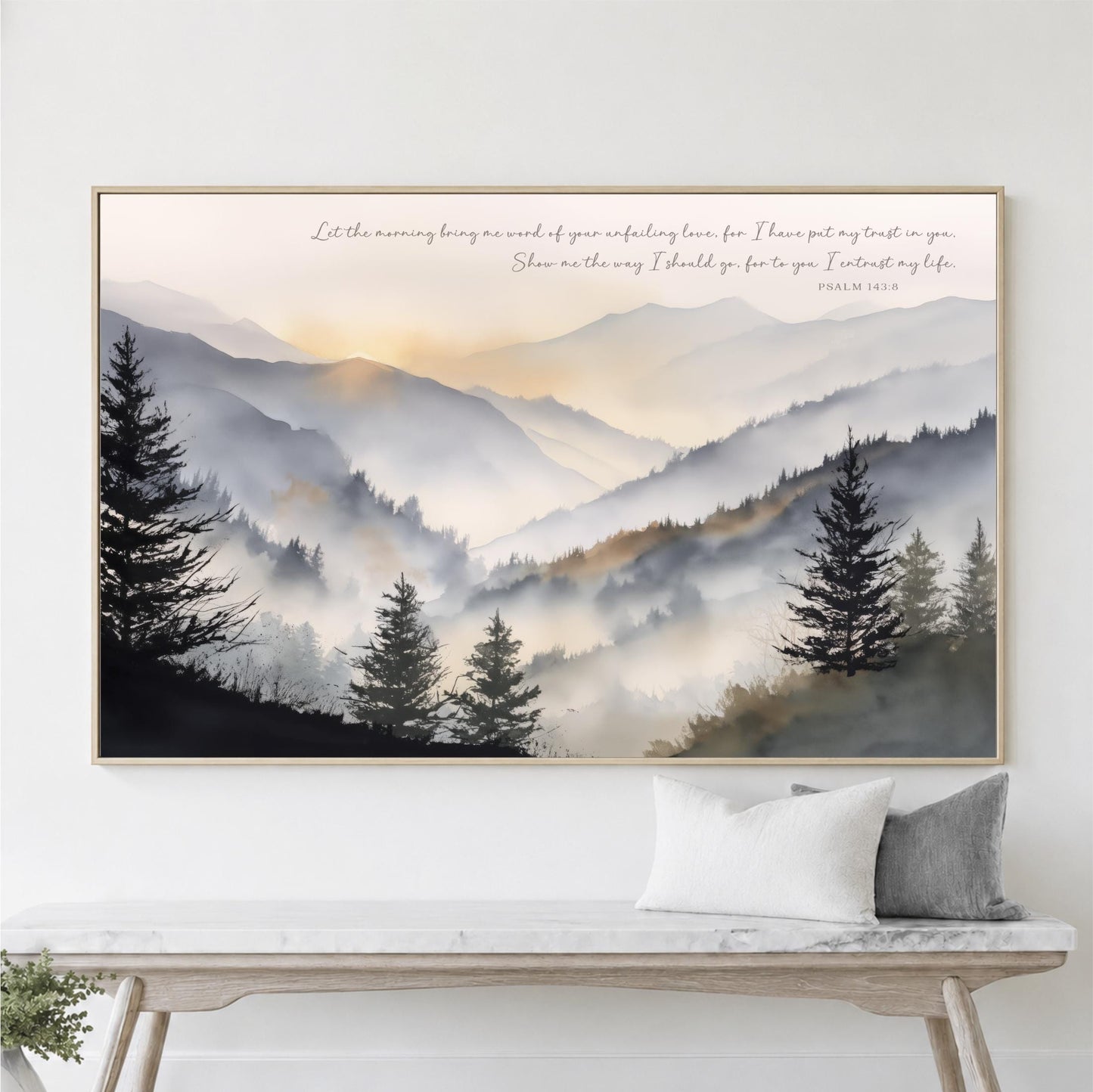 a large framed painting of a mountain landscape with pine trees and a misty, hazy atmosphere.