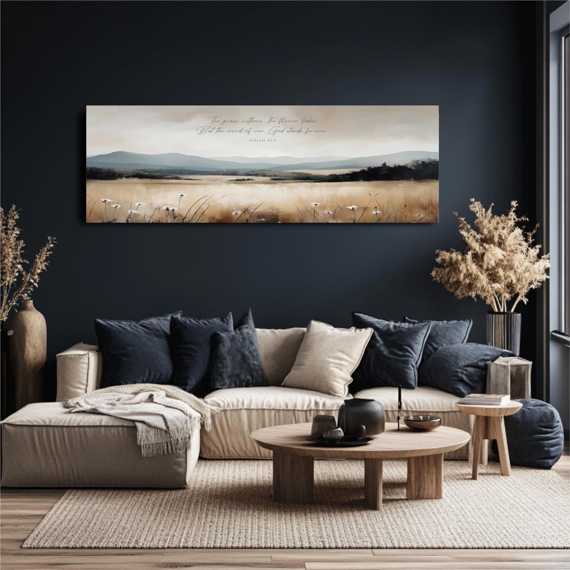 a cozy living room with a large painting of a field and mountains hanging on the wall. The room is furnished with a beige sofa, a wooden coffee table, and a potted plant. The painting adds a touch of nature and serenity to the space.