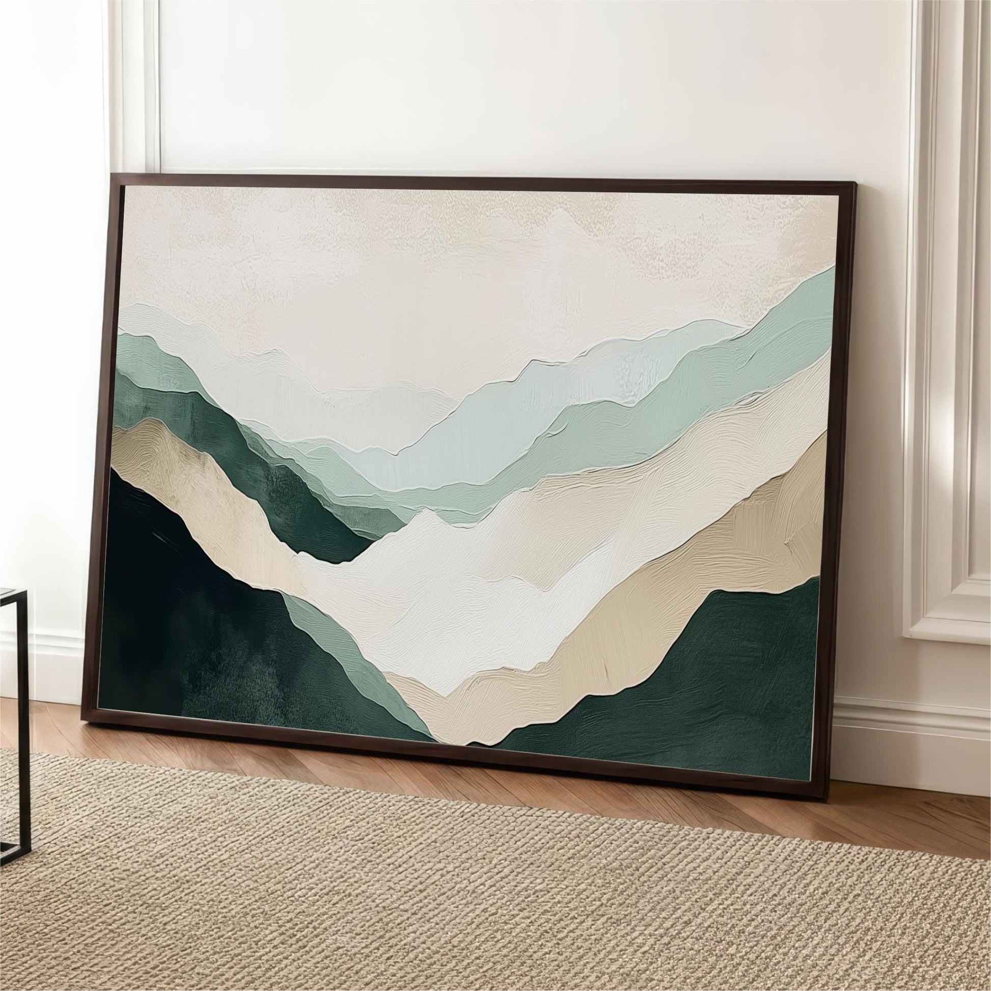 a large framed painting of mountains with a soothing color palette of green, beige, and gray.