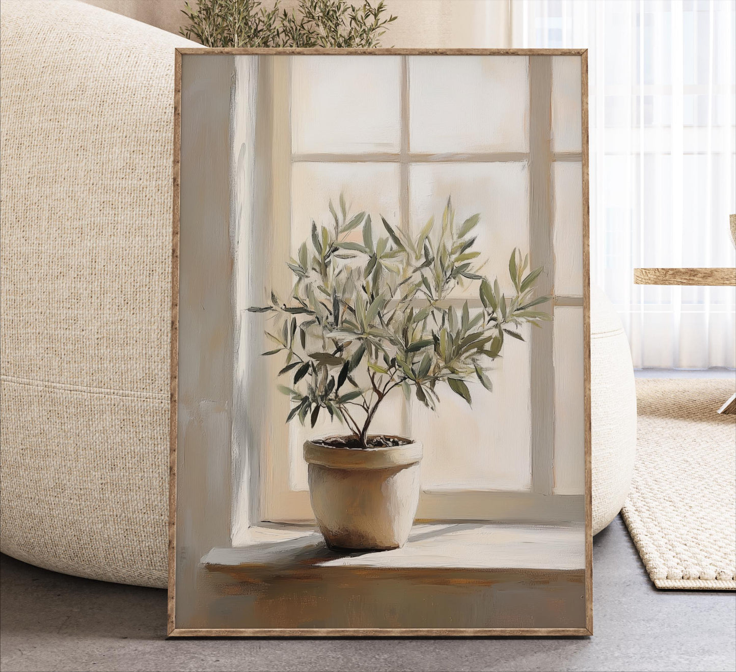 A potted olive tree sits on a windowsill, framed and displayed in a living room setting.