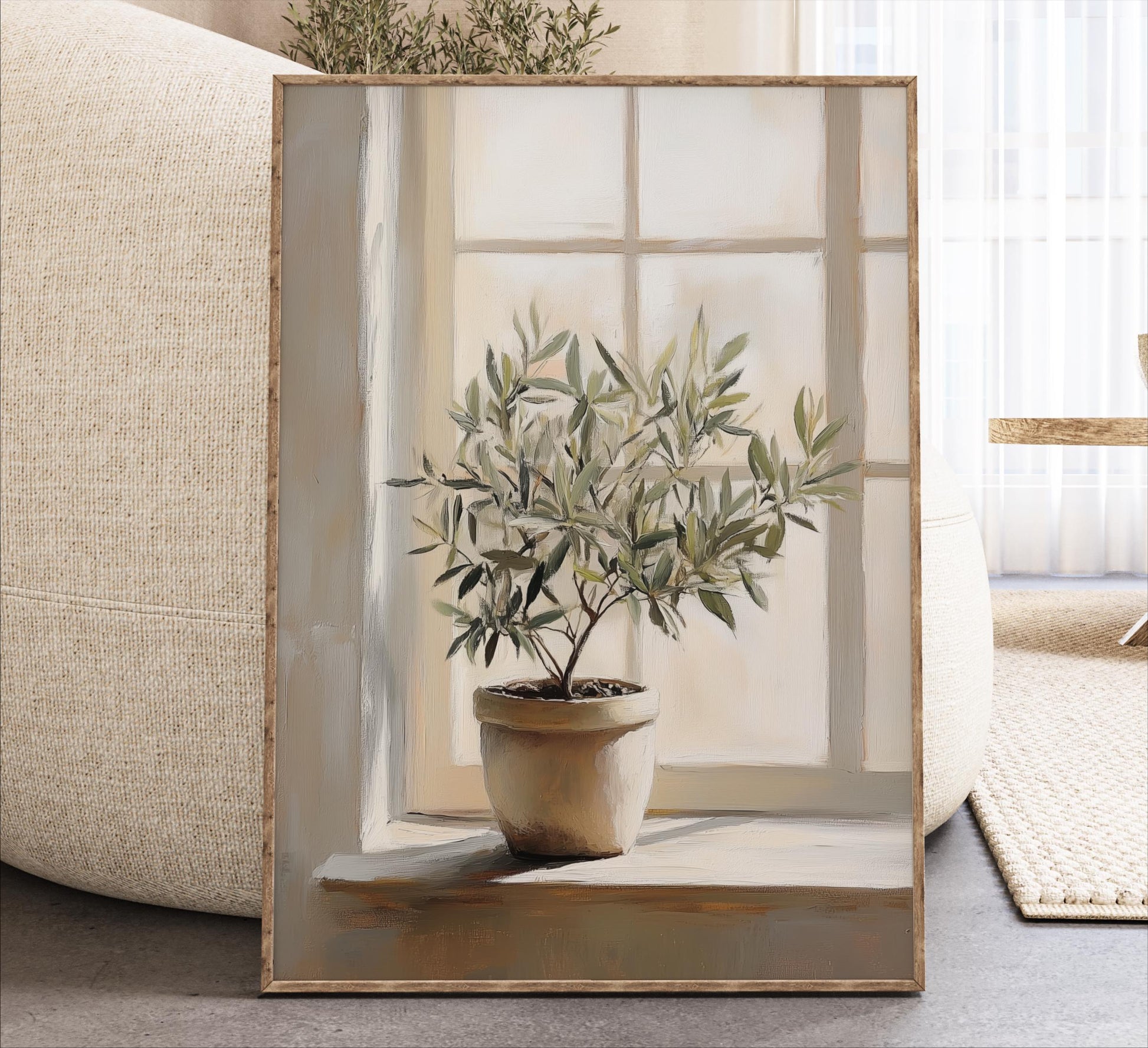 A potted olive tree sits on a windowsill, framed and displayed in a living room setting.