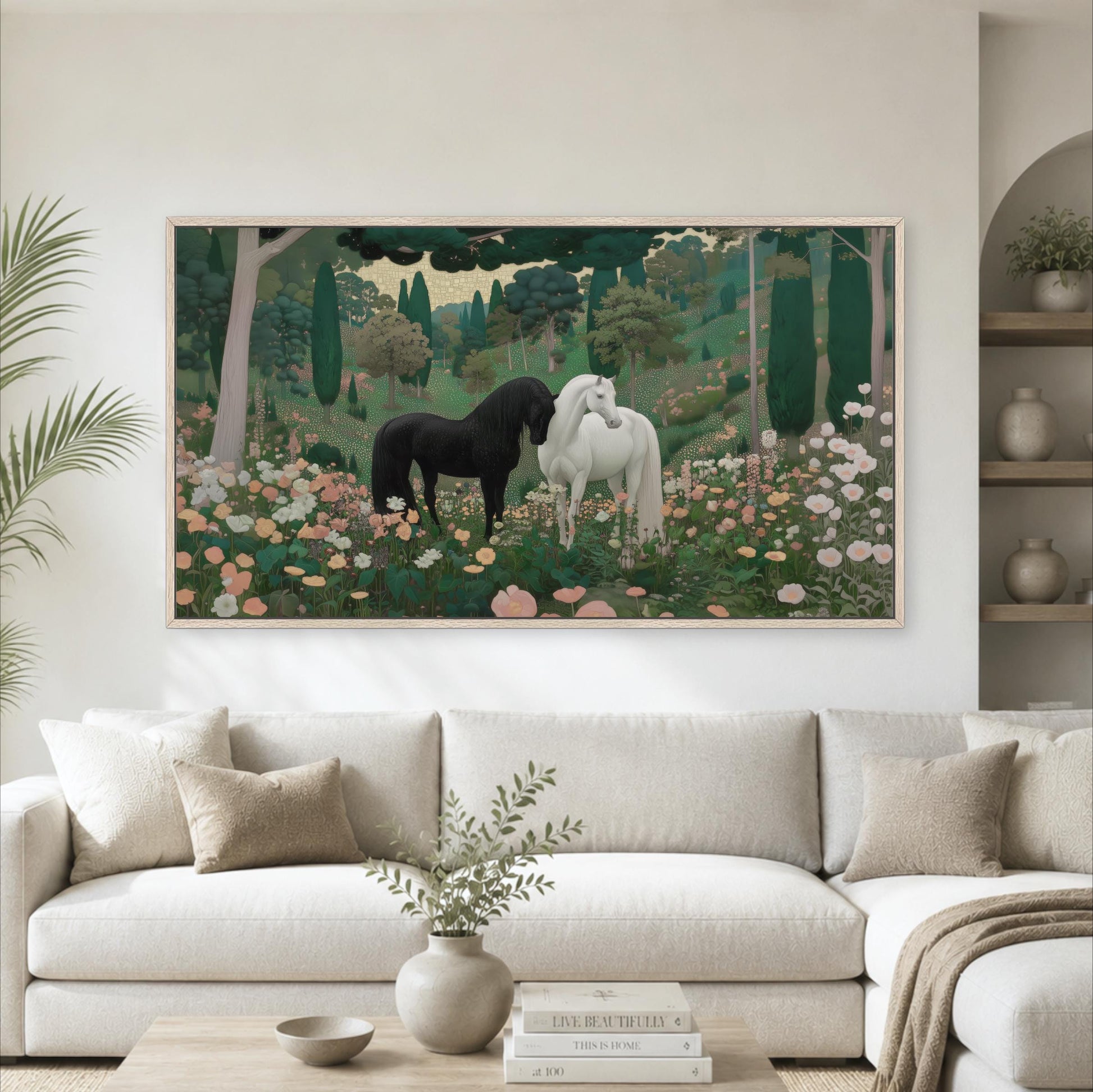 a large painting of two horses in a field of flowers, hanging on a wall above a white couch in a living room setting.