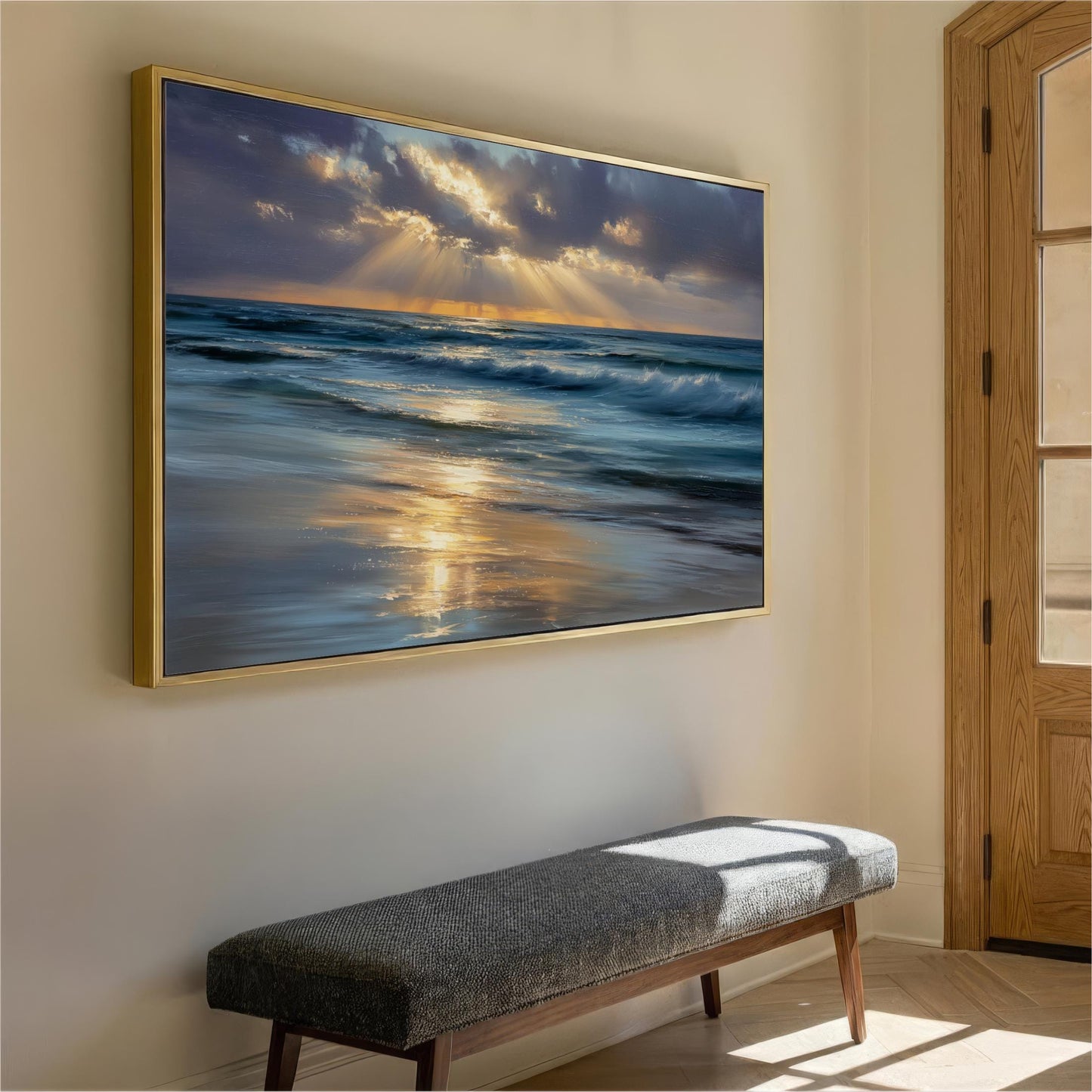 a large framed painting of a serene ocean scene with a golden sunset reflected on the water. The painting is hung on a wall above a gray bench, creating a peaceful and inviting atmosphere in the room.