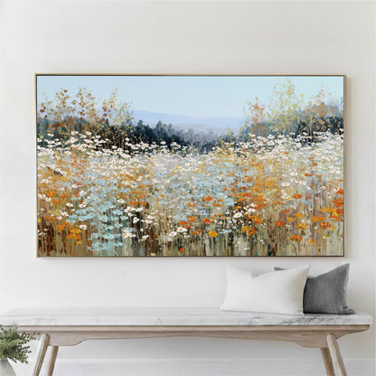 a large painting of a field of flowers hanging on a wall above a wooden bench.