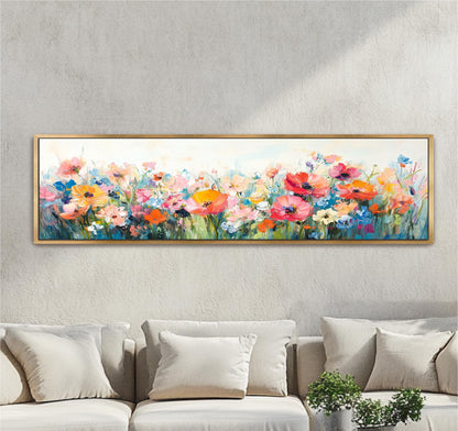 a large, colorful painting of a field of flowers hanging on a wall above a couch.