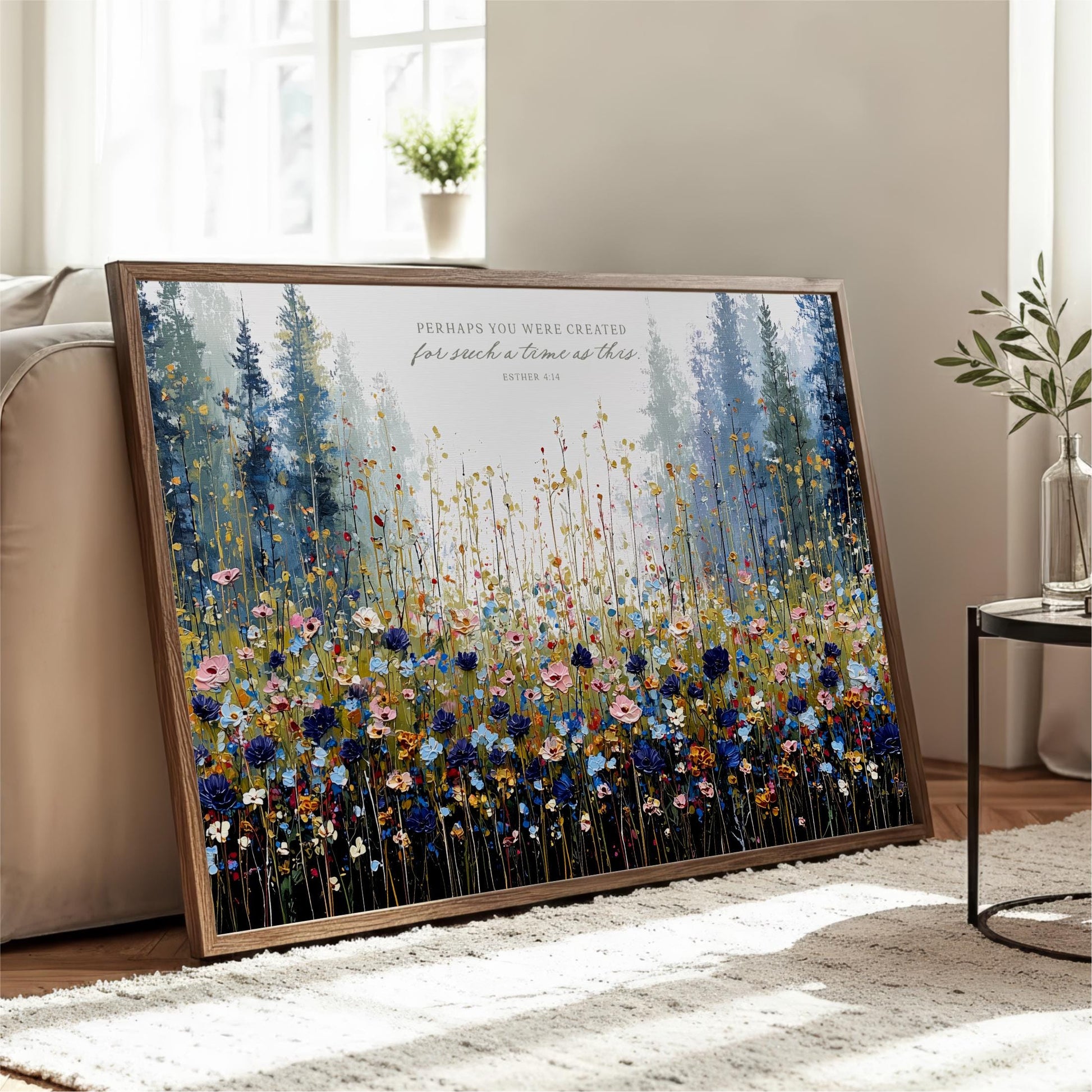 a large framed painting of a field of colorful flowers, with a potted plant and a window in the background.