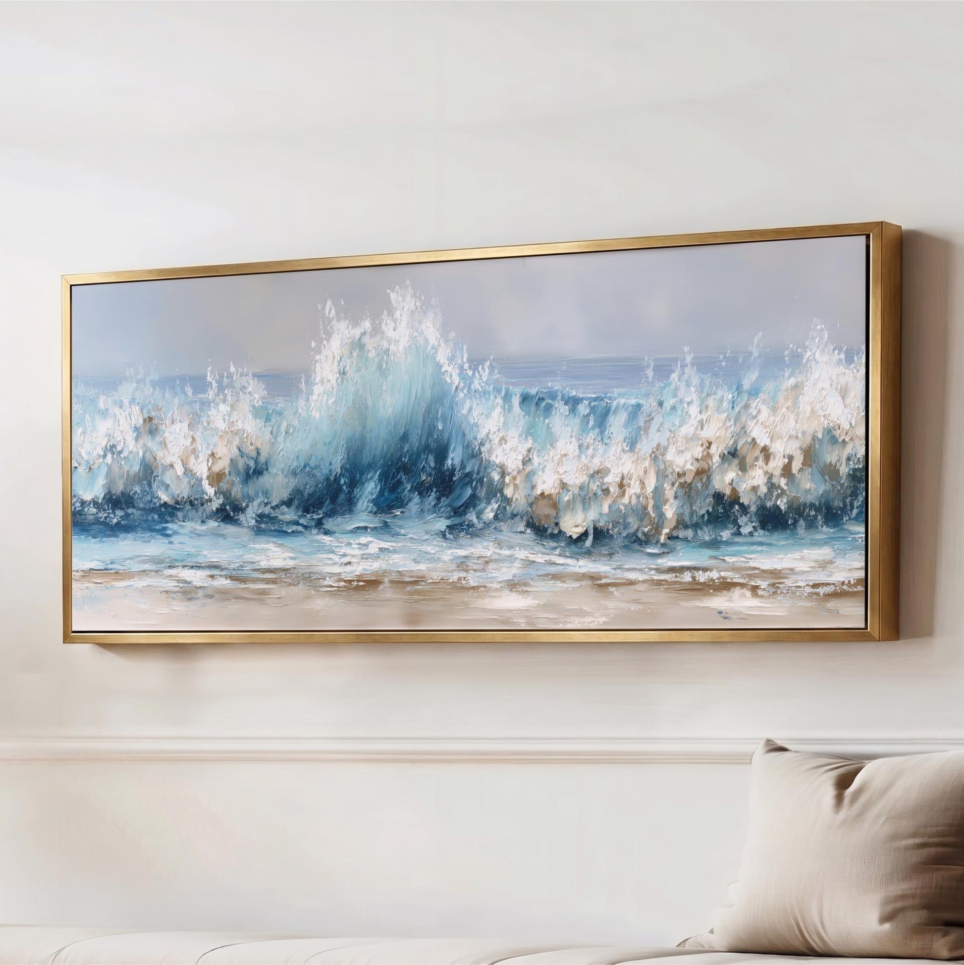 a large framed painting of a crashing wave, hanging on a wall above a couch.