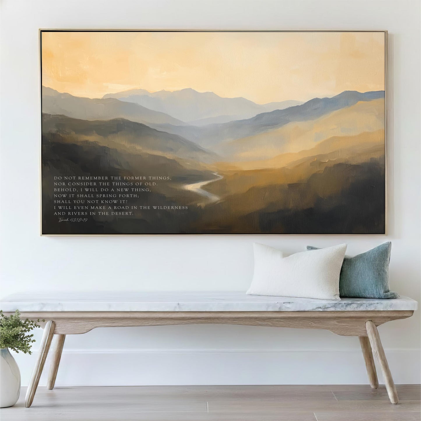 a large painting of a mountainous landscape hanging on a wall above a wooden bench with pillows.