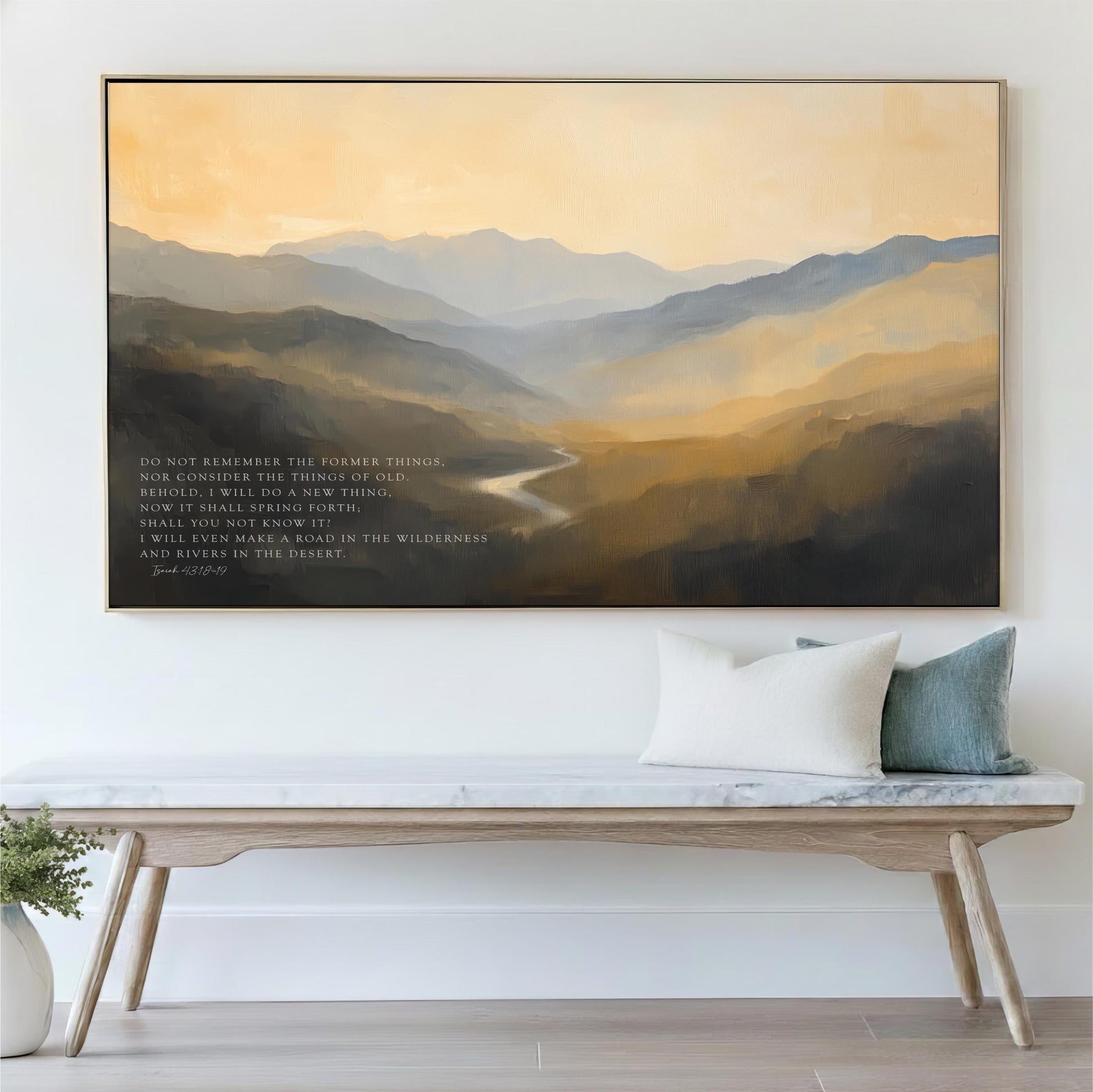 a large painting of a mountainous landscape hanging on a wall above a wooden bench with pillows.