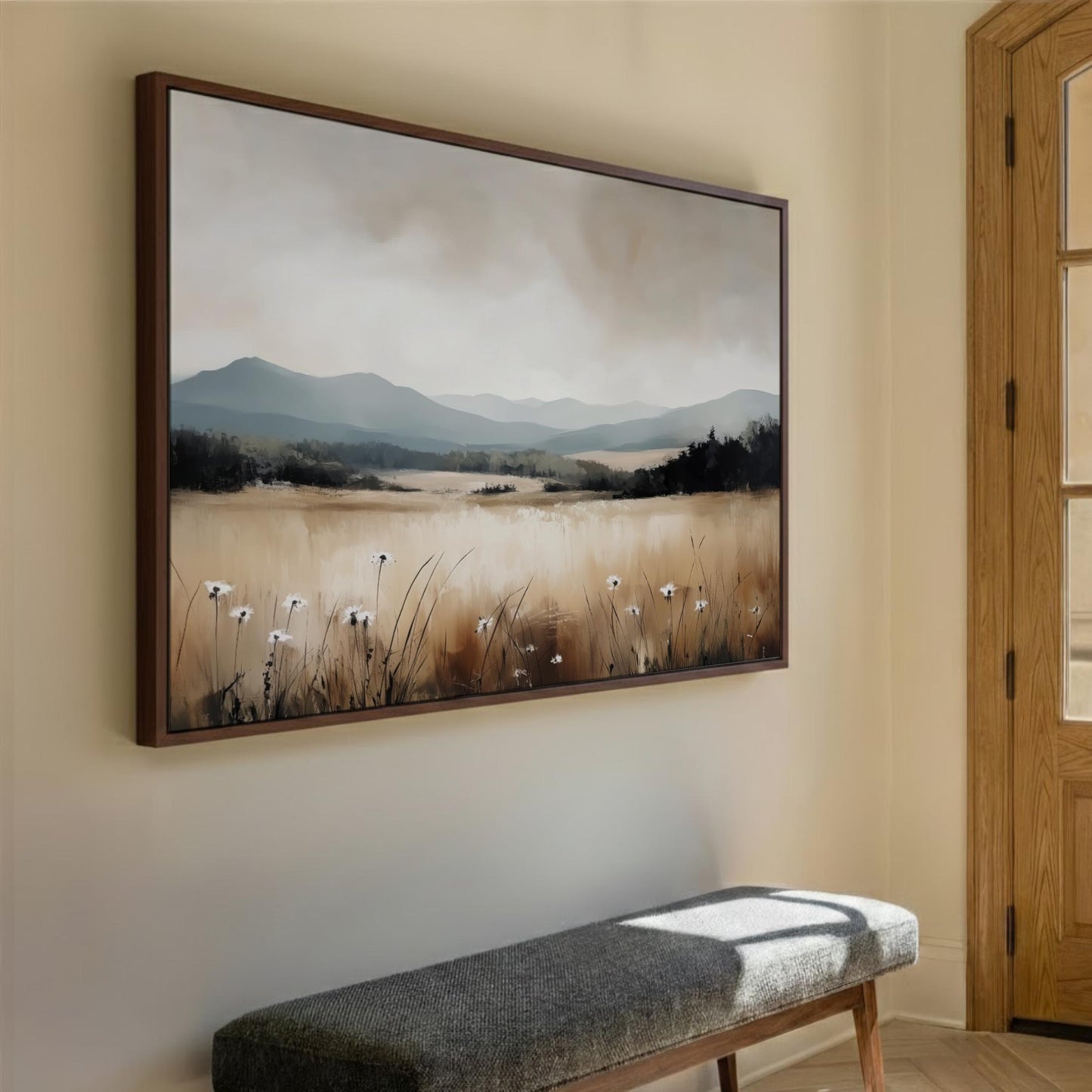 a large landscape painting hanging on a wall, depicting a field with flowers and mountains in the background.