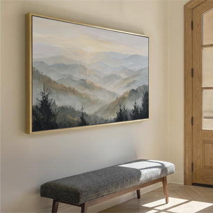 a large landscape painting hanging on a wall, depicting a serene mountain scene with trees and fog. In the foreground, there is a gray bench positioned against the wall, providing a seating area for viewers to appreciate the artwork.