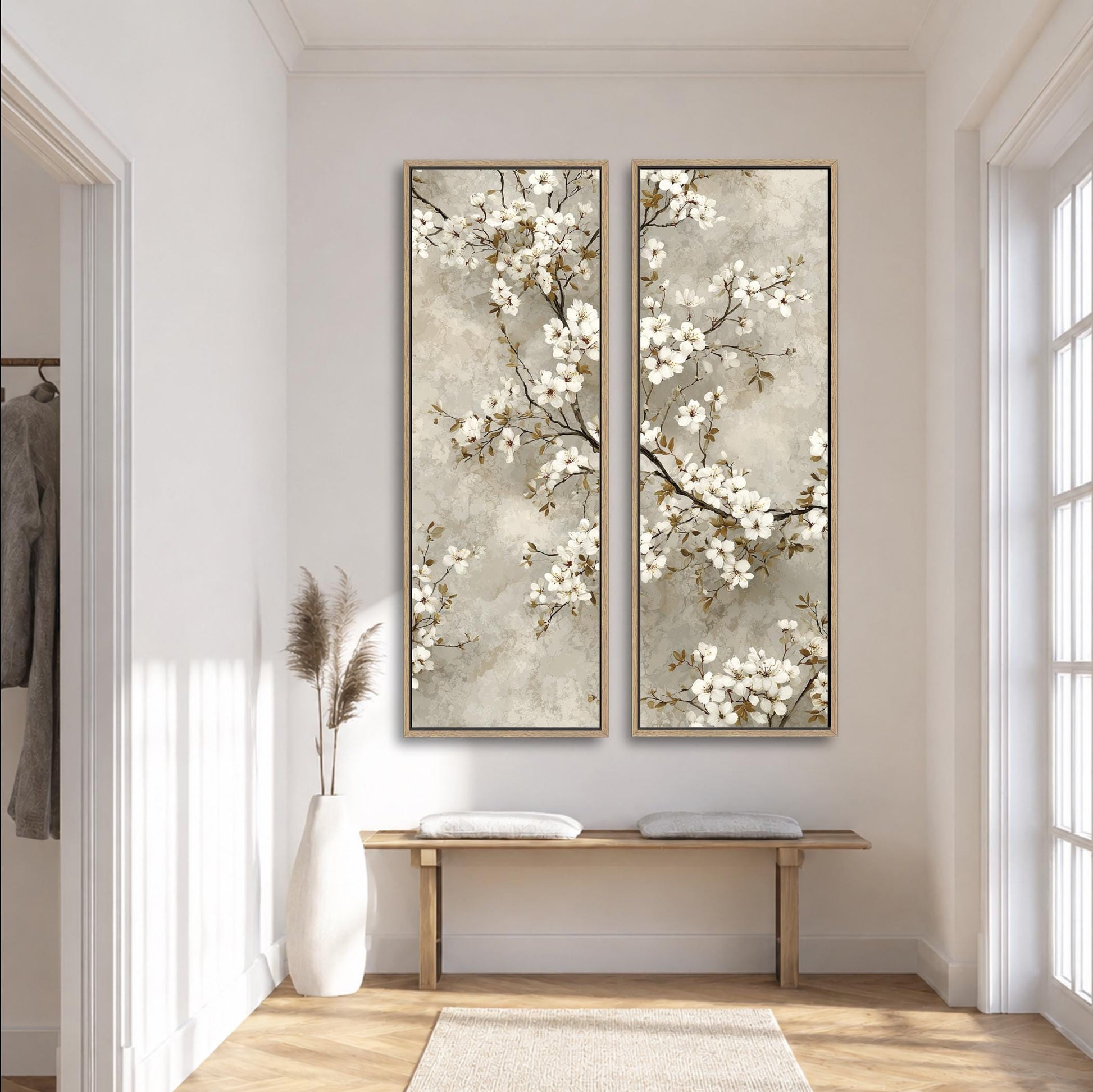 a serene and elegant hallway with a wooden bench, a tall white vase with dried flowers, and two large paintings of white flowers hanging on the wall.