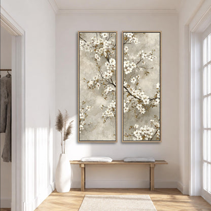 a serene and elegant hallway with a wooden bench, a tall white vase with dried flowers, and two large paintings of white flowers hanging on the wall.
