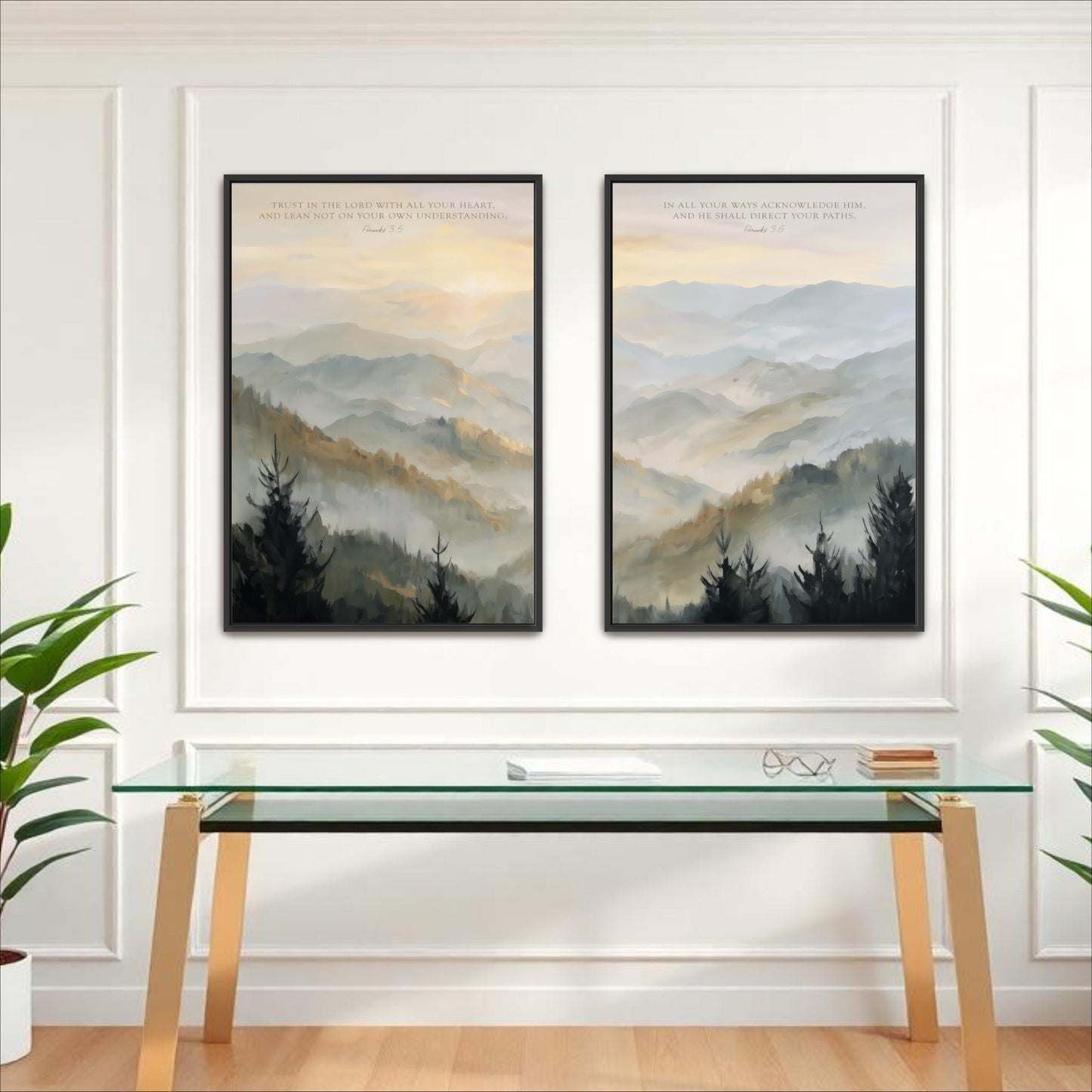two framed landscape paintings hanging on a white wall above a glass desk with a white surface.