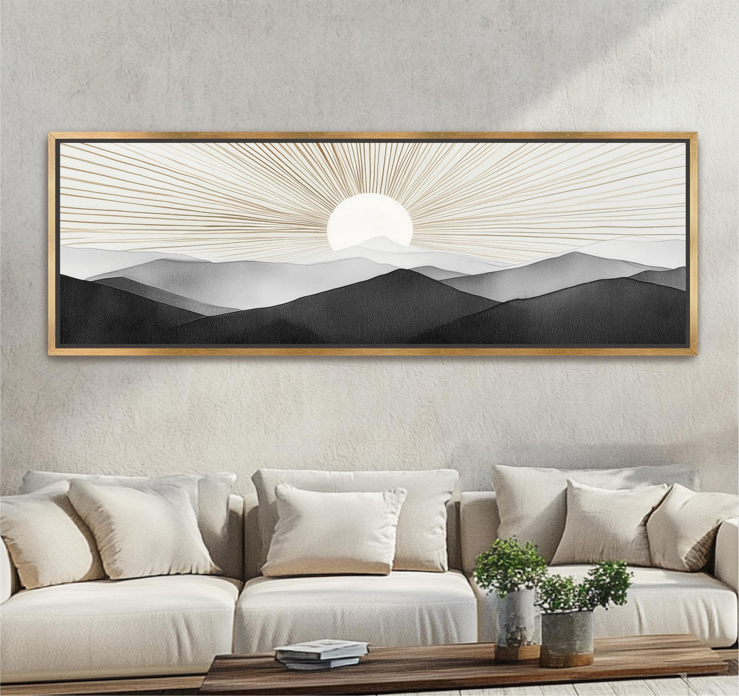 a large framed artwork depicting a serene landscape with mountains and a sun in the background, hanging on a wall above a beige sofa with white pillows.