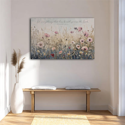 a large floral painting hanging on a white wall above a wooden bench with two cushions.