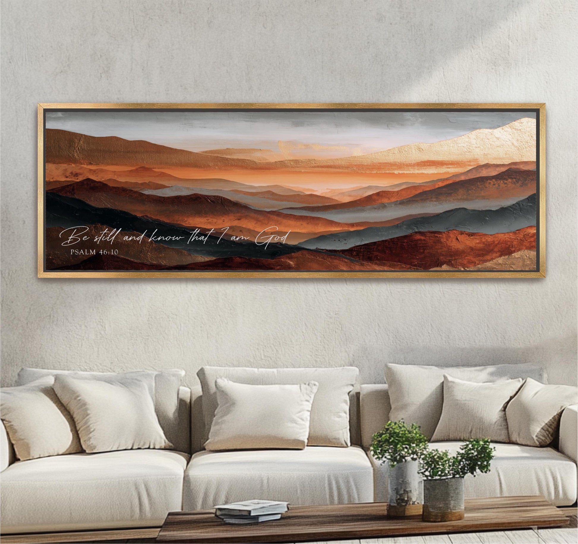 a large framed painting of a mountainous landscape with a serene and peaceful atmosphere, hanging on a wall above a couch and a coffee table.
