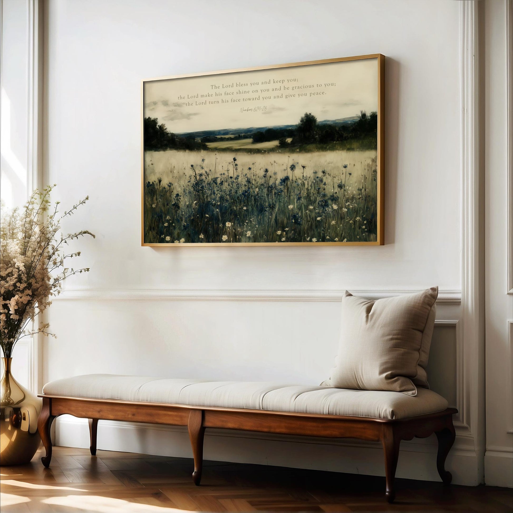 a serene indoor setting with a wooden bench, a vase of flowers, and a framed landscape painting hanging on the wall.