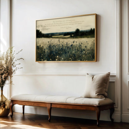 a serene indoor setting with a wooden bench, a vase of flowers, and a framed landscape painting hanging on the wall.