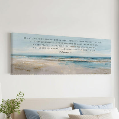 The image is a large canvas print featuring a serene beach scene with a blue sky and ocean. The text overlay provides a biblical quote from Philippians 4:1-7, which encourages the viewer to be anxious for nothing but in everything by prayer and supplication, with Thanksgiving, letting your requests be made known to God, and the peace of God, which surpasses all understanding. The quote also mentions that God will guard one's heart and mind through Christ Jesus.