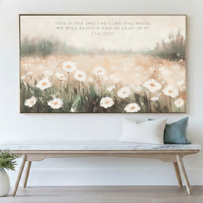 a large painting of a field of white flowers hanging on a wall above a wooden bench.