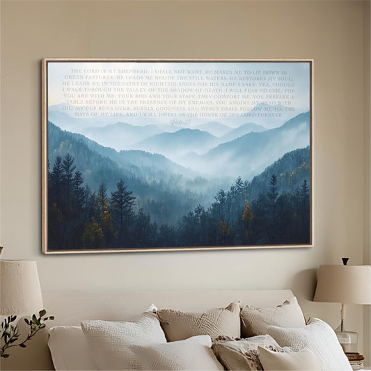 a large framed poster of a serene mountain landscape with trees and fog, hanging on a wall above a bed with white pillows.