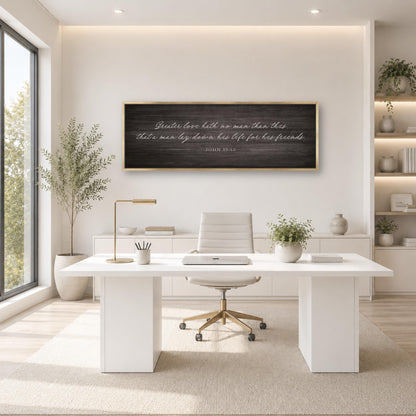 A modern, minimalist office space with a large window, white desk, and a framed inspirational quote on the wall.