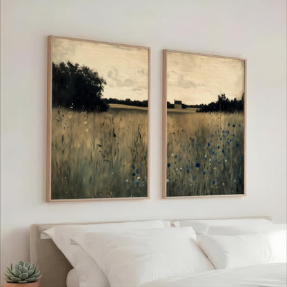 two large paintings of a field with tall grass and trees, hanging on a wall above a bed with white pillows.