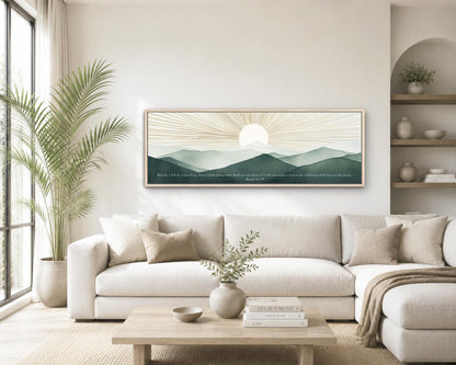 a serene living room with a large white sofa, a wooden coffee table, and a framed landscape painting of a sunrise over mountains. The painting is hung on the wall above the sofa, creating a focal point in the room. The room is decorated with potted plants, vases, and books, adding a cozy and inviting atmosphere.