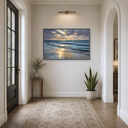 a serene hallway with a large painting of a beach scene hanging on the wall, featuring a blue sky, ocean waves, and a sunset. The painting is framed in black and is placed above a small table with a plant on it. The hallway has a rug on the floor and a doorway on the right side, creating a cozy and inviting atmosphere.