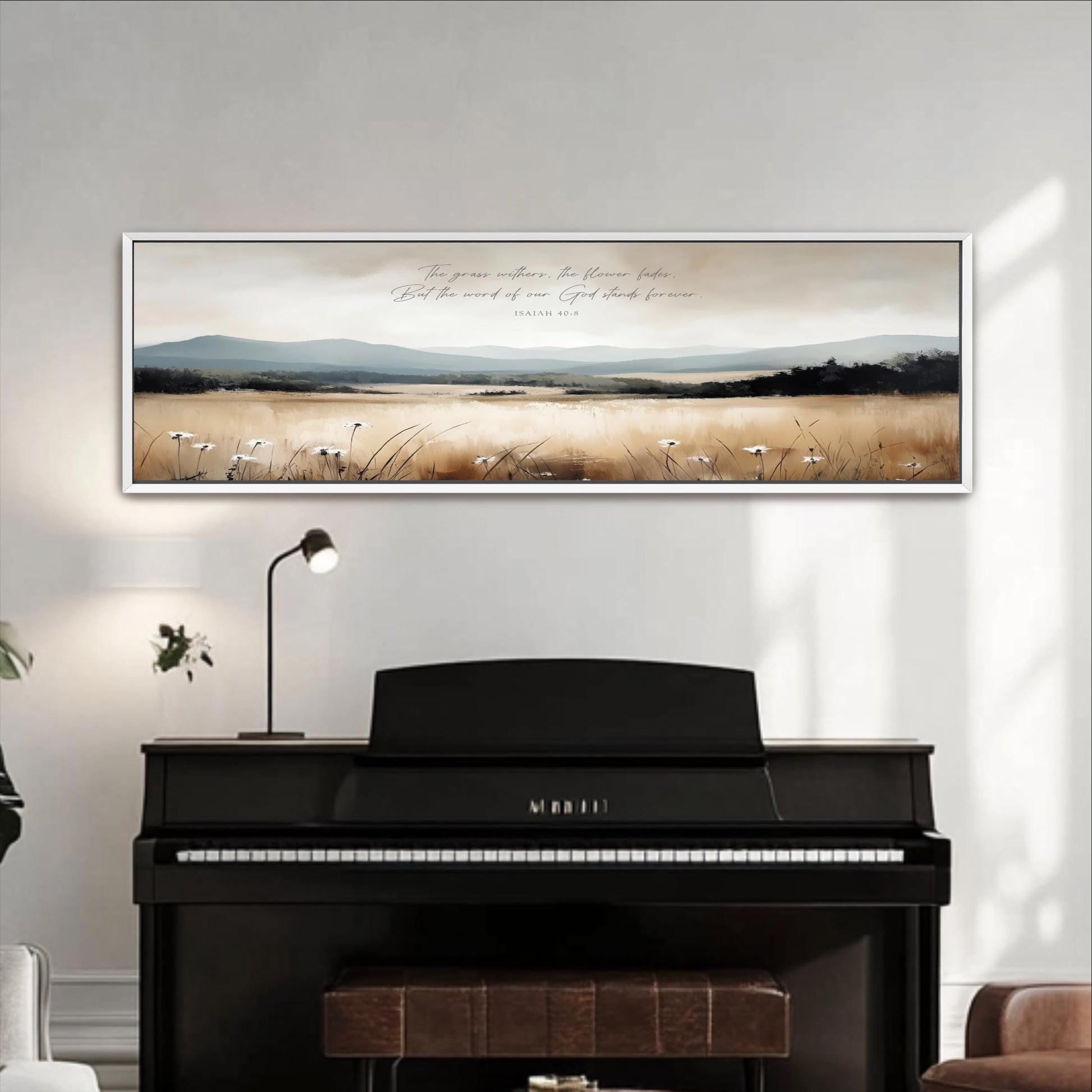 a black piano with a framed landscape painting above it, depicting a serene countryside scene with mountains and a field of flowers.
