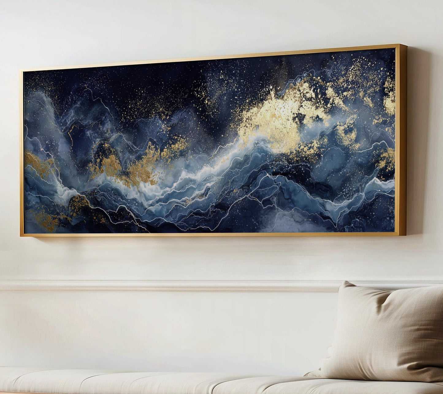 a large, framed painting of a swirling, abstract ocean scene with a dark blue background and gold accents, hanging on a white wall above a couch.