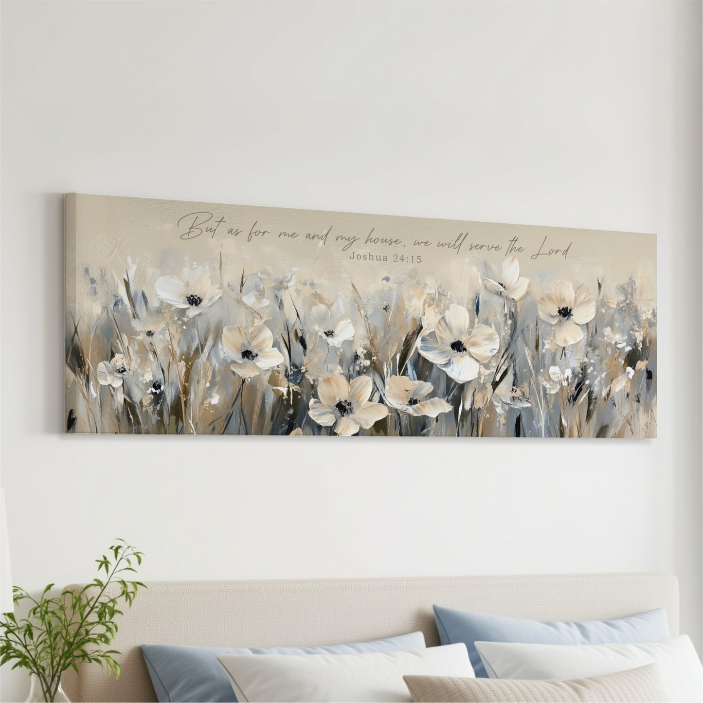 a large canvas print of a field of white flowers hanging on a wall above a bed with pillows.
