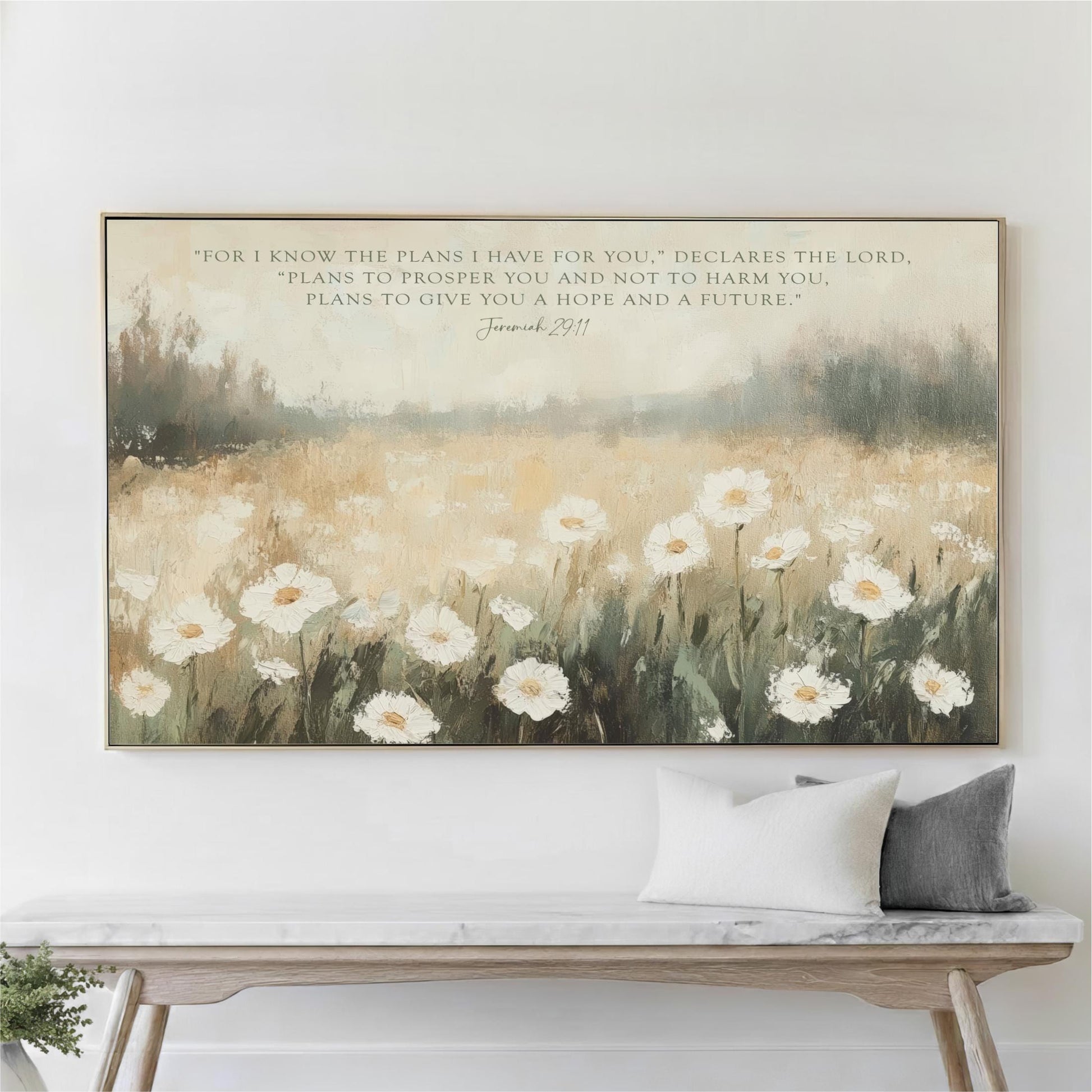 a large painting of a field of white flowers hanging on a wall above a wooden bench.