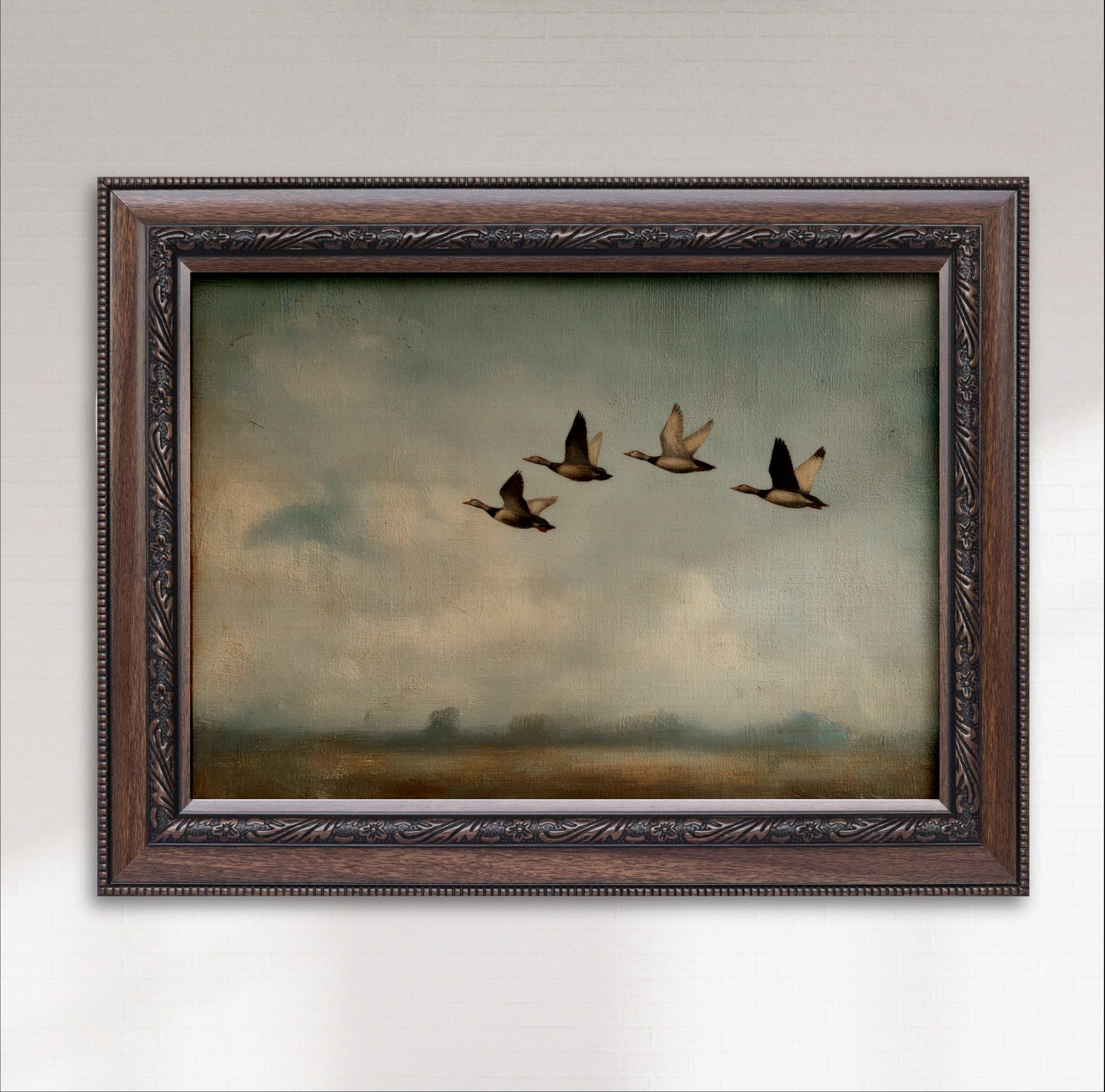A framed painting depicting four ducks flying in formation against a cloudy sky.