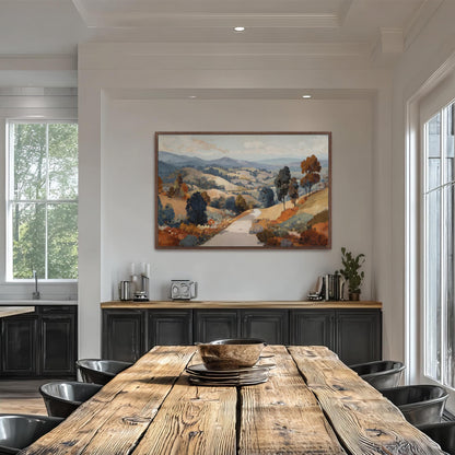 a large, colorful landscape painting hanging on a white wall above a wooden dining table. The table is surrounded by black chairs, and there are several books and decorative items on the table.