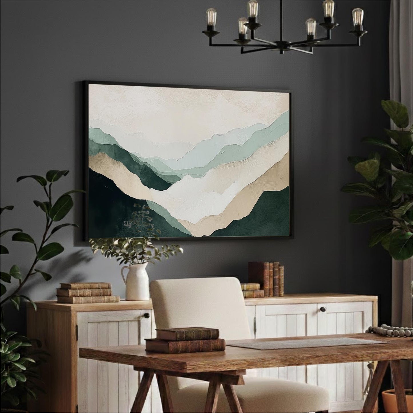 a modern and stylish home office with a large abstract painting of mountains hanging on the wall above a wooden desk. The desk is surrounded by a white chair and has several books and plants on it. The room also features a chandelier and a plant, creating a cozy and inviting atmosphere.
