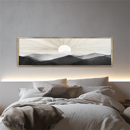 a large, framed painting of a sunrise over mountains hanging above a bed with white bedding.